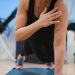 A woman in a black tank top is doing yoga